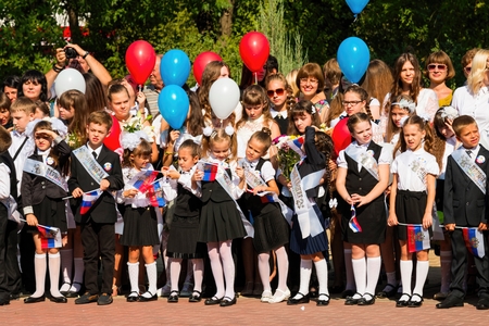 Rostov - on - Don, Russia - September 1, 2015: School line is in schoolyard with first-grade pupils and teacher. Children go back to school. The Knowledge Day in Russia, first day of school.のeditorial素材