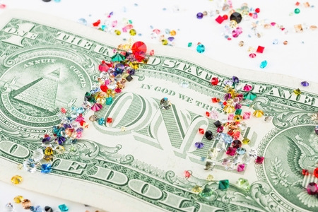 Collection of many different natural gemstones and USA dollar.の写真素材