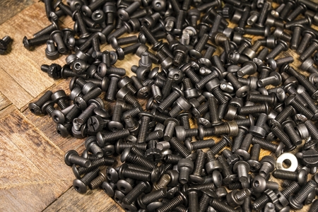 A pile of computer metallic screws. Macro shot.