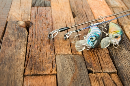 Fishing baits on wooden background. Macro shot.の写真素材