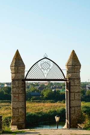 Wrought iron gate at the entrance to the city park.の写真素材