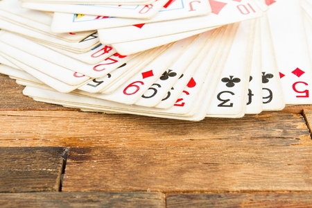 Playing cards on wooden background. Macro shot.