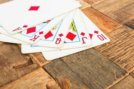 Poker cards, Royal flash on wooden background. Macro shot.の写真素材