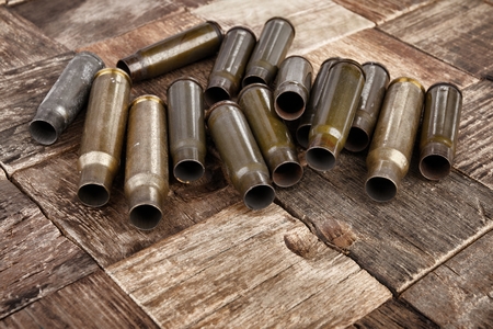 Bullets shells on wooden background. Stock image macro.の写真素材