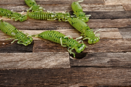 Fishing jig baits on wooden background. Macro shot.の写真素材