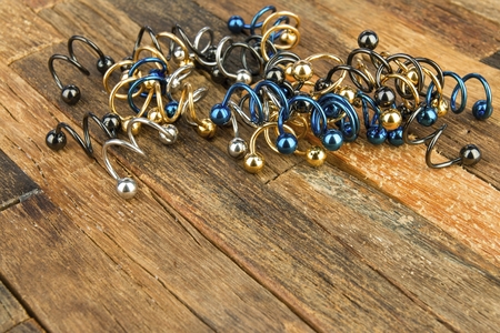 Jewelry for piercing on wooden background. Stock Image macro.の写真素材