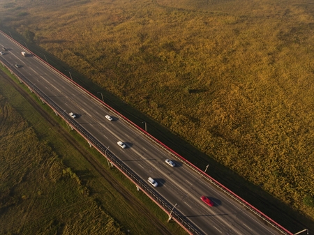 Autumn morning fog over highway. Aerial view.