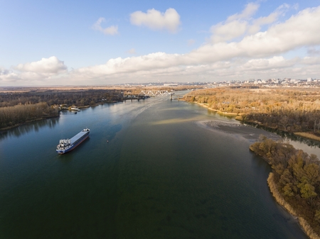 Cargo ship in beautiful river. Aerial view. Autumn landscape.の写真素材