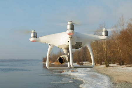 Rostov - on - Don, Russia - January 04, 2017: Flying drone quadcopter Dji Phantom 4 with high...