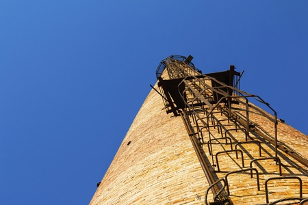 Factory chimney. Old crumbling pipe made of bricks. Steadicam shot.の写真素材