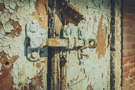 Old antique door with chipped paint and rusted lock. Macro shot.の写真素材