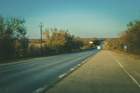 Long asphalt road at sunset. Scenic spring sunset.の写真素材