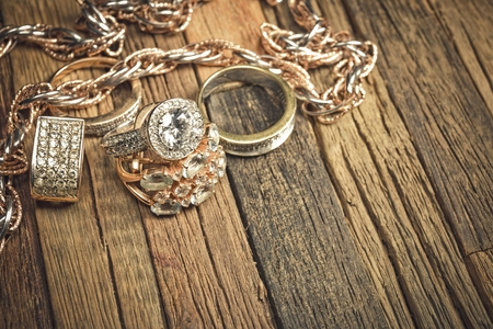 Beautiful golden jewelry on wooden background. Macro shot.の写真素材