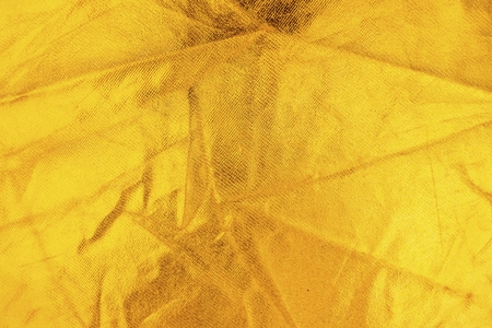Gold thread on the fabric. Gold texture glitter background. Macro shot.の写真素材