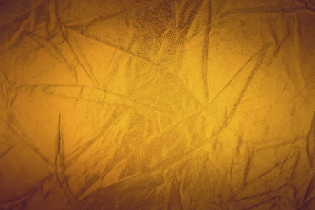 Gold thread on the fabric. Gold texture glitter background. Macro shot.の写真素材