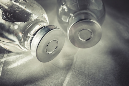 Glass medicine vials with liquid. Macro shot.