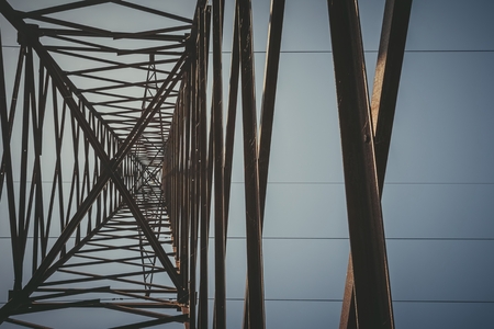 High voltage power pylons against blue sky. Transmission power line.の写真素材