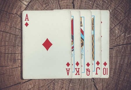 Playing cards on wooden surface. Royal flush.の写真素材