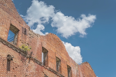 Abandoned house, ruined wall against the blue sky with clouds. Stock image.の写真素材