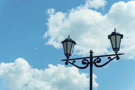 Old lamp post against blue sky with clouds. Stock image.の写真素材
