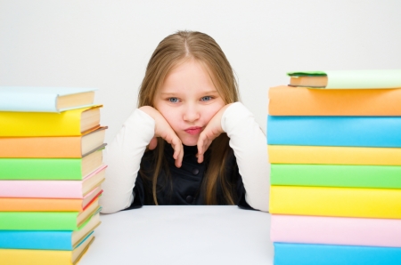 Cute girl with colored booksの写真素材