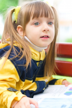 Young girl reading a book  at the parkの写真素材