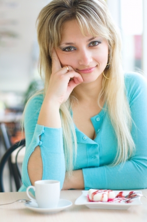 Young beautiful woman with a cakeの写真素材