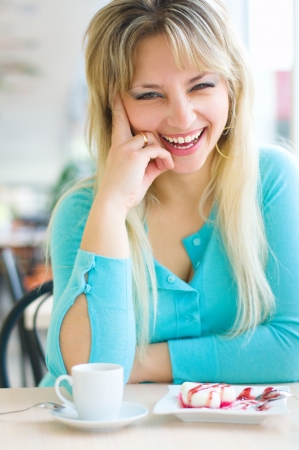 Young beautiful woman with a cakeの写真素材