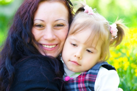 Bright picture of hugging mother and daughterの写真素材