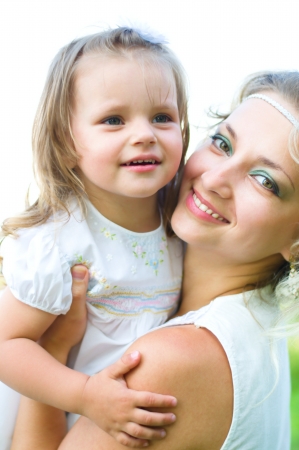 Happy mother and daughter laughing together outdoorsの写真素材