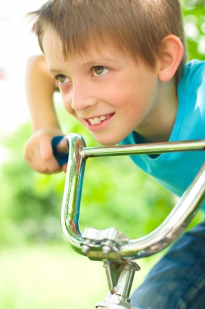 Portrait of a cute boy on bicycleの写真素材