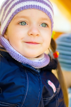 autumn portrait of a cute little girl outdoorsの写真素材