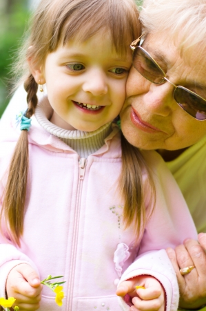 Portrait Of Grandmother With Granddaughter Relaxing Togetherの写真素材