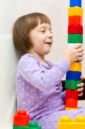 cute little girl playing with colorful building blocksの写真素材