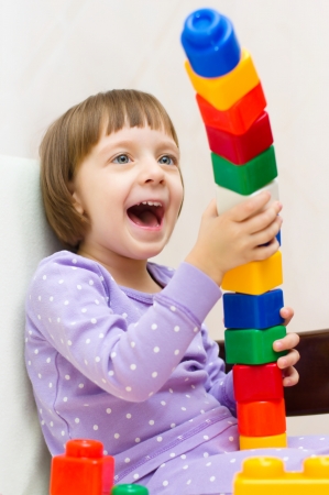 cute little girl playing with colorful building blocksの写真素材