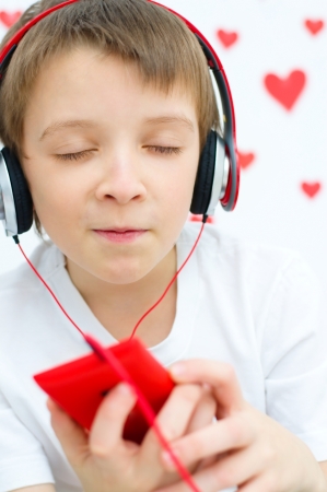 cute boy is listening to the musicの写真素材