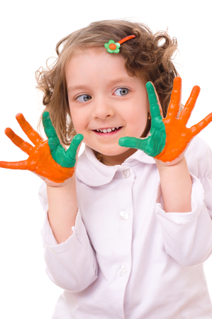 cute cheerful girl showing her hands painted in bright colors, isolated over whiteの写真素材