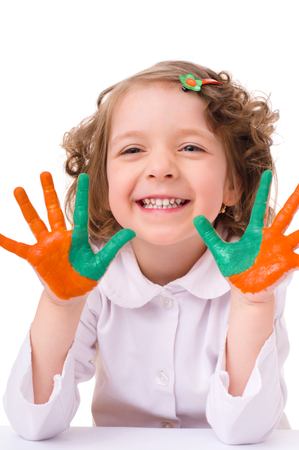 cute cheerful girl showing her hands painted in bright colors, isolated over whiteの写真素材