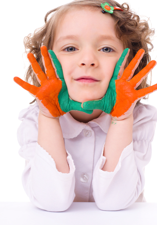cute cheerful girl showing her hands painted in bright colors, isolated over whiteの写真素材