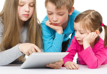 children using tablet computer, isolated over whiteの写真素材