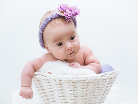 adorable  newborn baby girl in the basketの写真素材