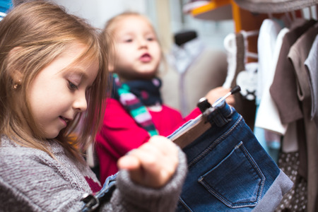 Beautiful girl shopping for clothes at a retail storeの写真素材