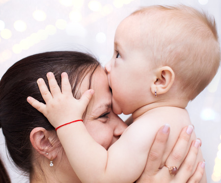 Family concept. Happy young mother playing with babyの写真素材