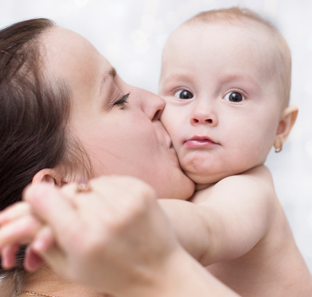 Family concept. Happy young mother playing with babyの写真素材