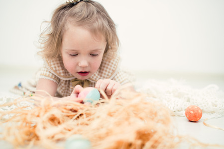 Cute little girl with colorful easter eggsの写真素材