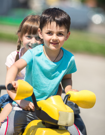Funny boy and girl  with car driver with the steering wheelの写真素材