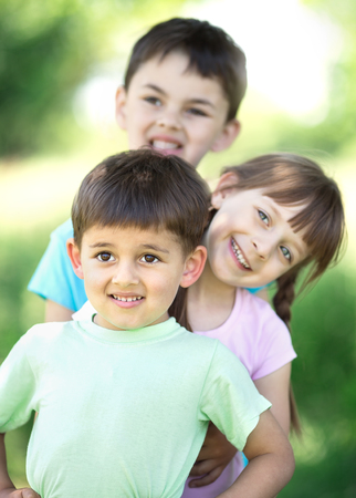 summer portrait of happy children together outdoorの写真素材