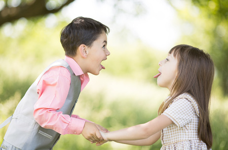 Adorable happy kids couple outdoorsの写真素材