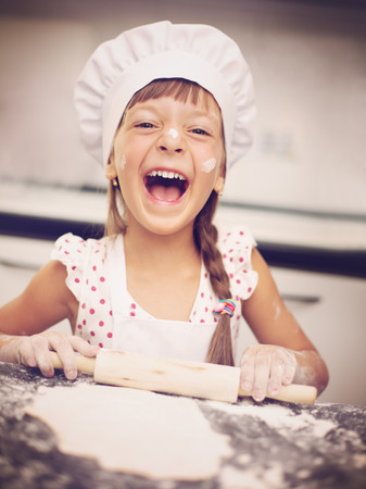 Cooking is fun. Little girl playing with flourの写真素材