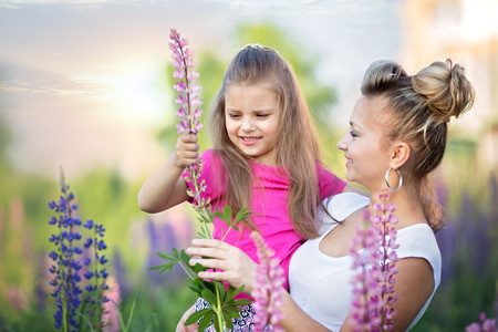 Cute little girl hugging her mother outdoorsの写真素材